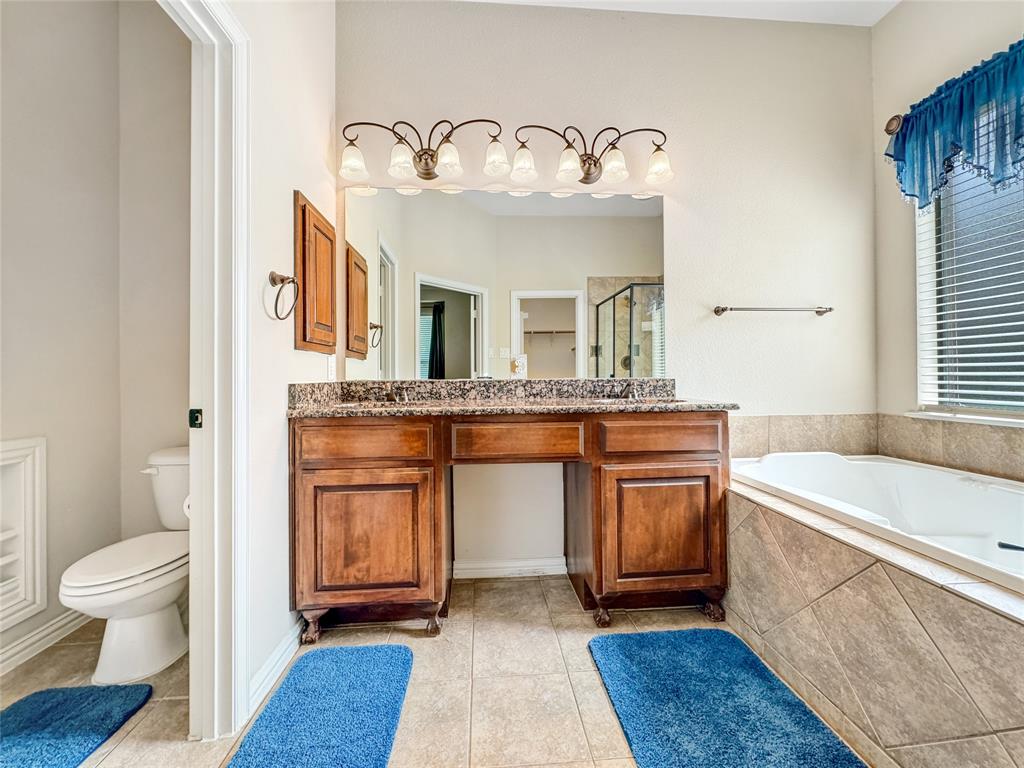 401 Varnum Way Fairview, TX 75069 - Photo 19 of 33 a spacious bathroom with a granite countertop sink and a mirror