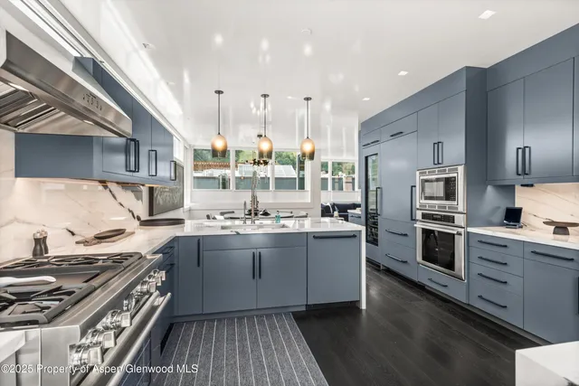 a kitchen with stainless steel appliances granite countertop a stove and a sink