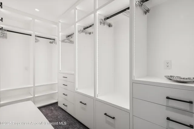 a spacious bedroom with a bed and window