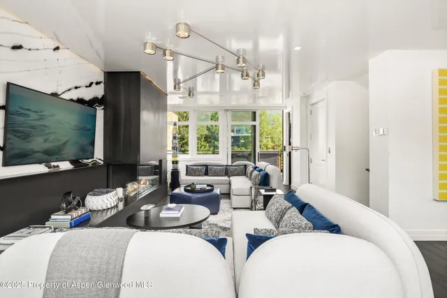 a living room with furniture fireplace and a flat screen tv