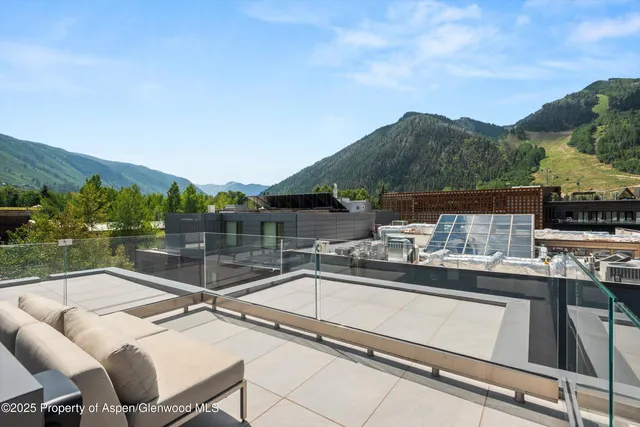 a view of a balcony with two chairs and a couch