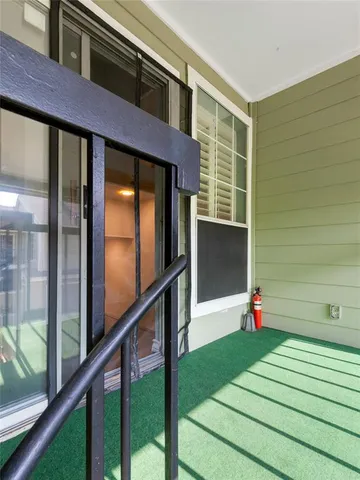 a view of a patio with couches chairs and wooden fence
