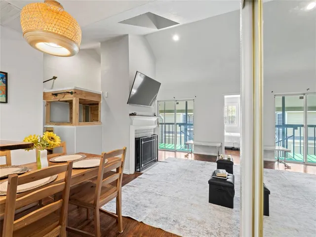 a living room with furniture a fireplace and a table