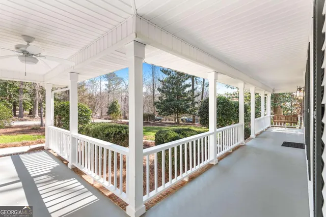 an empty room with a window and ceiling fan