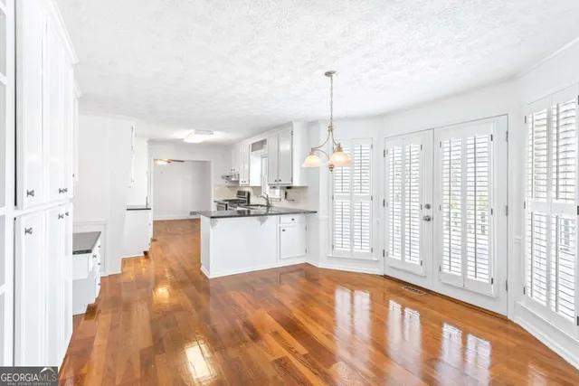 a view of a kitchen with wooden floor
