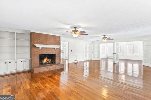 a view of an empty room and wooden floor