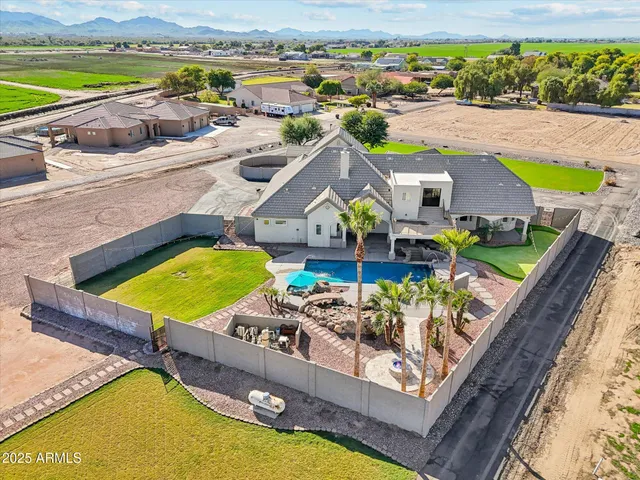 an aerial view of a house with a swimming pool yard and outdoor seating