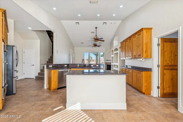 a kitchen with stainless steel appliances granite countertop a sink stove and cabinets