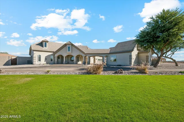 a view of a house with swimming pool and sitting area