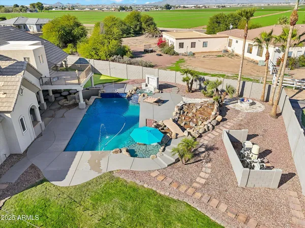 an aerial view of a house with garden patio and lake view