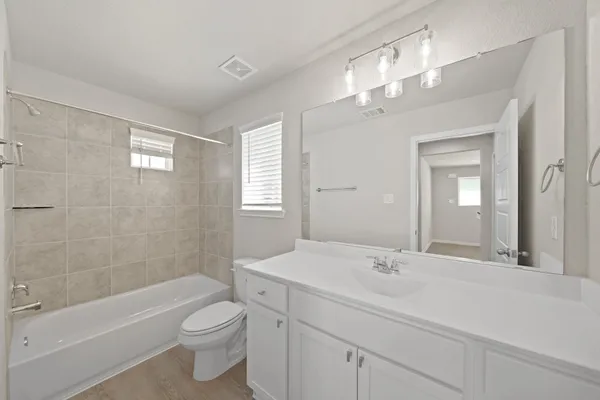 a bathroom with a sink a toilet and bathtub