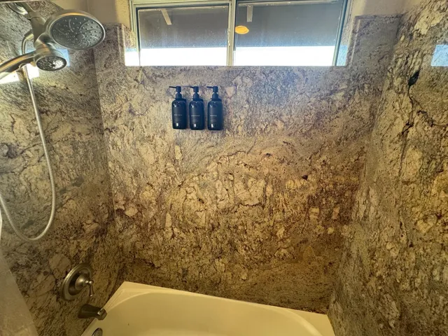 a bed sitting in a room next to a window