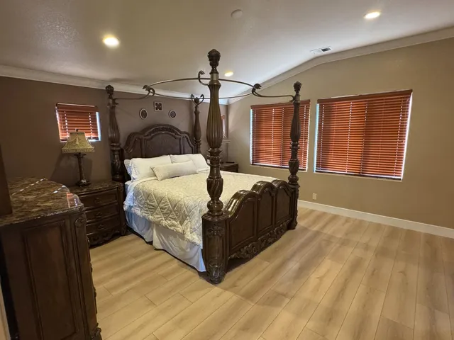 a bedroom with a bed and a large window