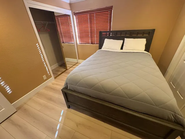 a bedroom with a bed and a mirror