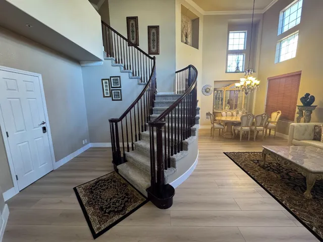 a view of entryway and hall with wooden floor