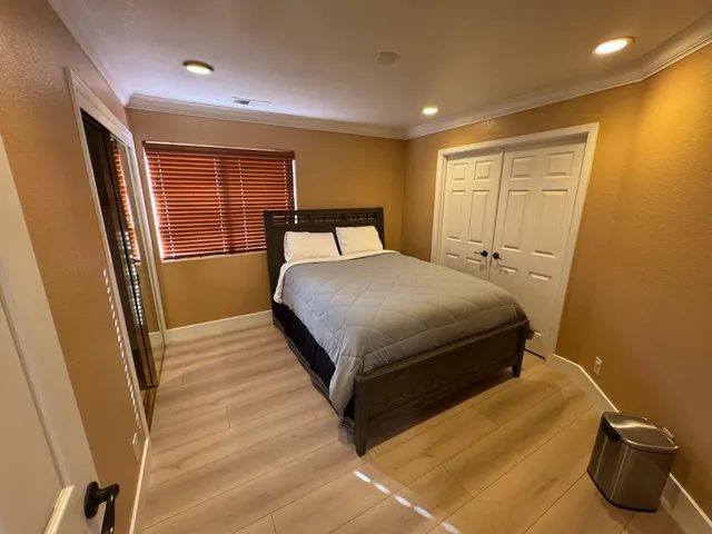 a bedroom with a bed and a dresser