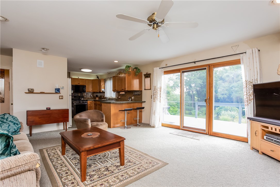 2066 Boston Neck Road North Kingstown, RI 02874 - Photo 12 of 35 This open kitchen / living space has a fireplace and extra large sliders leading to the deck and yard.