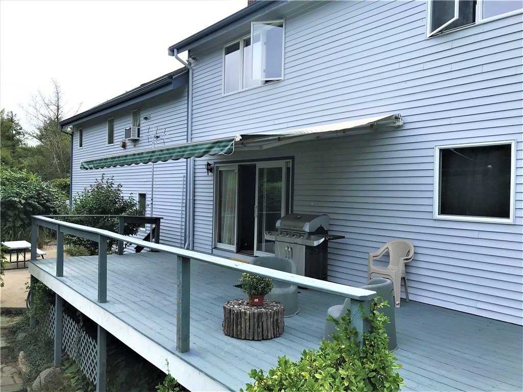 2066 Boston Neck Road North Kingstown, RI 02874 - Photo 25 of 35 Large deck with retractable awning gives wonderful shade on a hot sunny day.