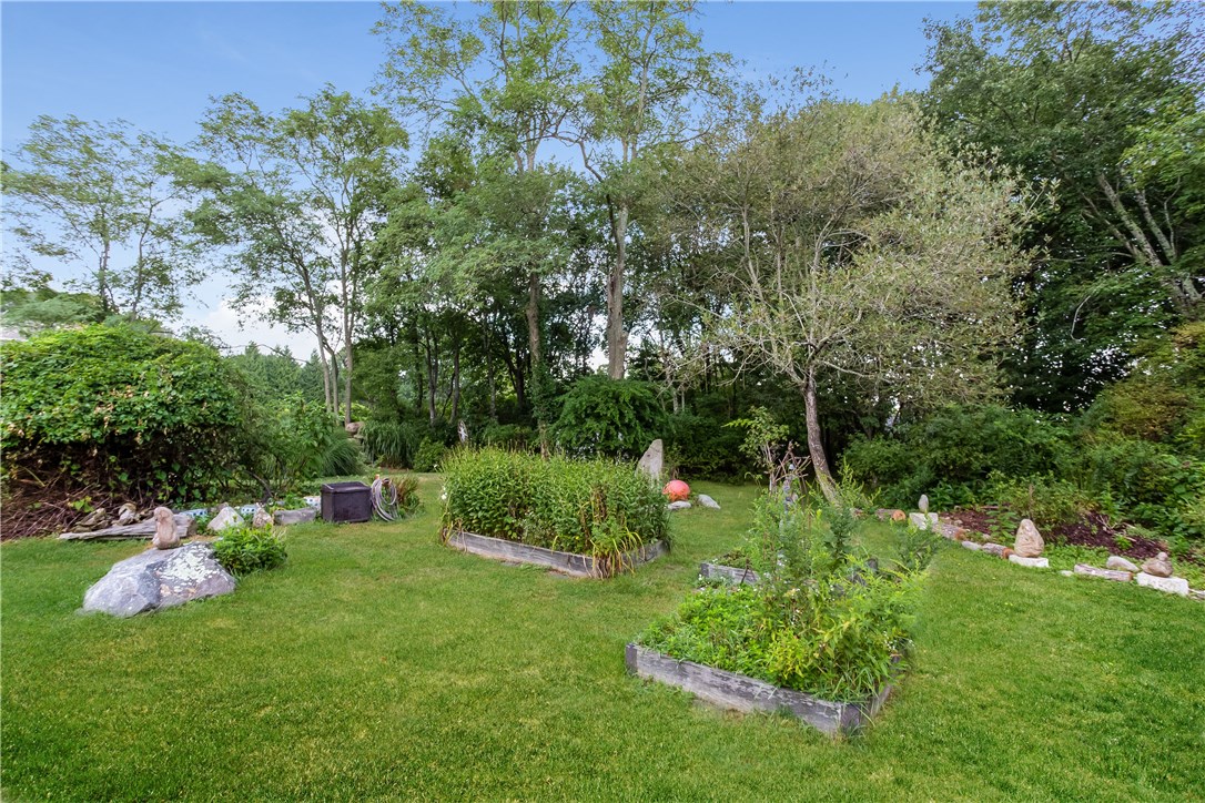 2066 Boston Neck Road North Kingstown, RI 02874 - Photo 30 of 35 The backyard is filled with special plantings and mature trees.