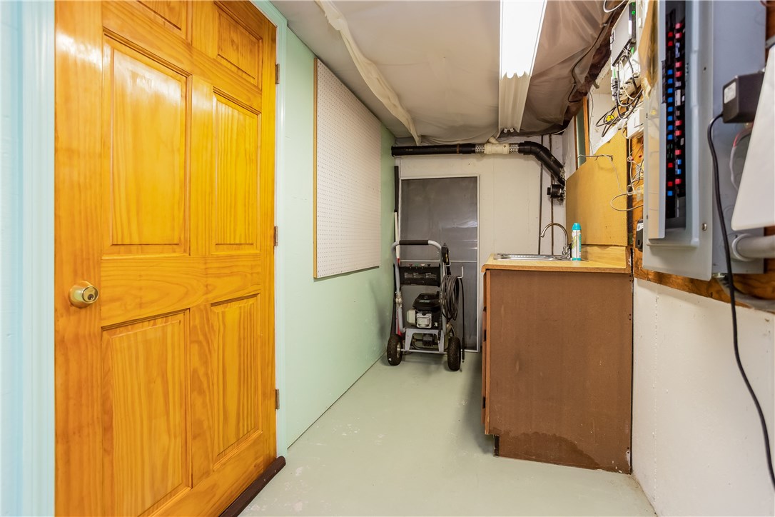 2066 Boston Neck Road North Kingstown, RI 02874 - Photo 31 of 35 The large basement has a walkout door under the deck. Perfect for expansion if you need more living space. This is one little corner with the electrical and generator panels.