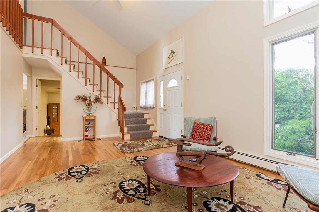 2066 Boston Neck Road North Kingstown, RI 02874 - Photo 5 of 35 Bright and light living room has a cathedral ceiling and open concept living connecting to the dining room, kitchen area and great room.