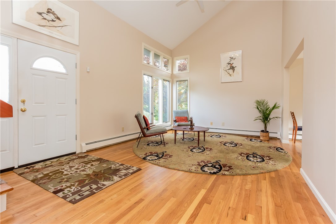 2066 Boston Neck Road North Kingstown, RI 02874 - Photo 6 of 35 The front door opens into this beautiful living room with hardwood floors stretching right into the dining room.