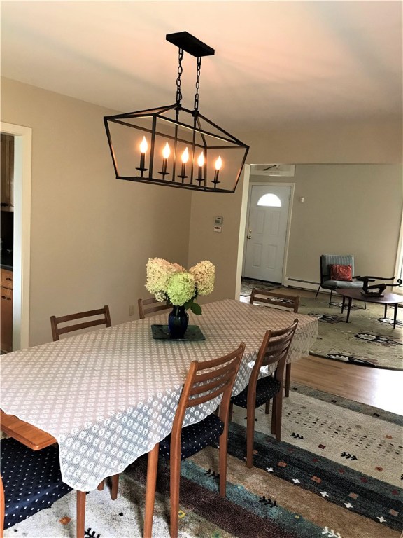 2066 Boston Neck Road North Kingstown, RI 02874 - Photo 7 of 35 Large dining room allows for a long table and opens to the living room and kitchen. A beautiful bay window brightens the space.