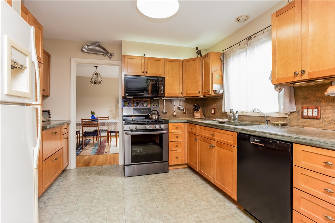 2066 Boston Neck Road North Kingstown, RI 02874 - Photo 9 of 35 This updated kitchen has shaker cabinets, an new gas range, custom concrete counters, and opens right to a comfortable fireplaced living space.