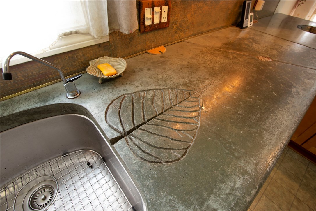2066 Boston Neck Road North Kingstown, RI 02874 - Photo 10 of 35 The custom concrete counter has this beautiful leaf drain for drying dishes.