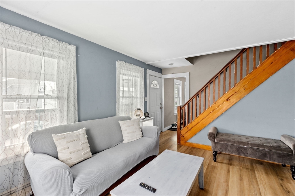 435 Newport Road Hull, MA 02045 - Photo 14 of 35 a living room with furniture stairs and a window