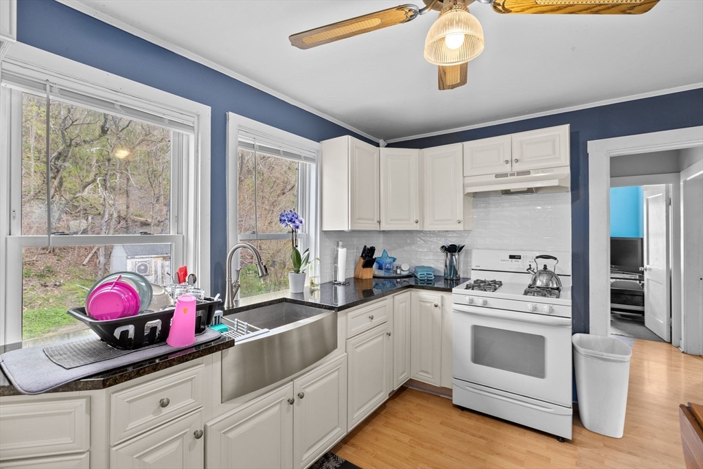 435 Newport Road Hull, MA 02045 - Photo 21 of 35 a kitchen with kitchen island white cabinets and white appliances