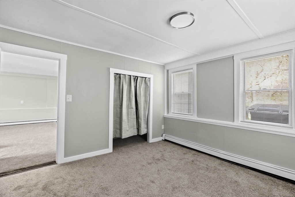 435 Newport Road Hull, MA 02045 - Photo 5 of 35 an empty room with a empty space and windows
