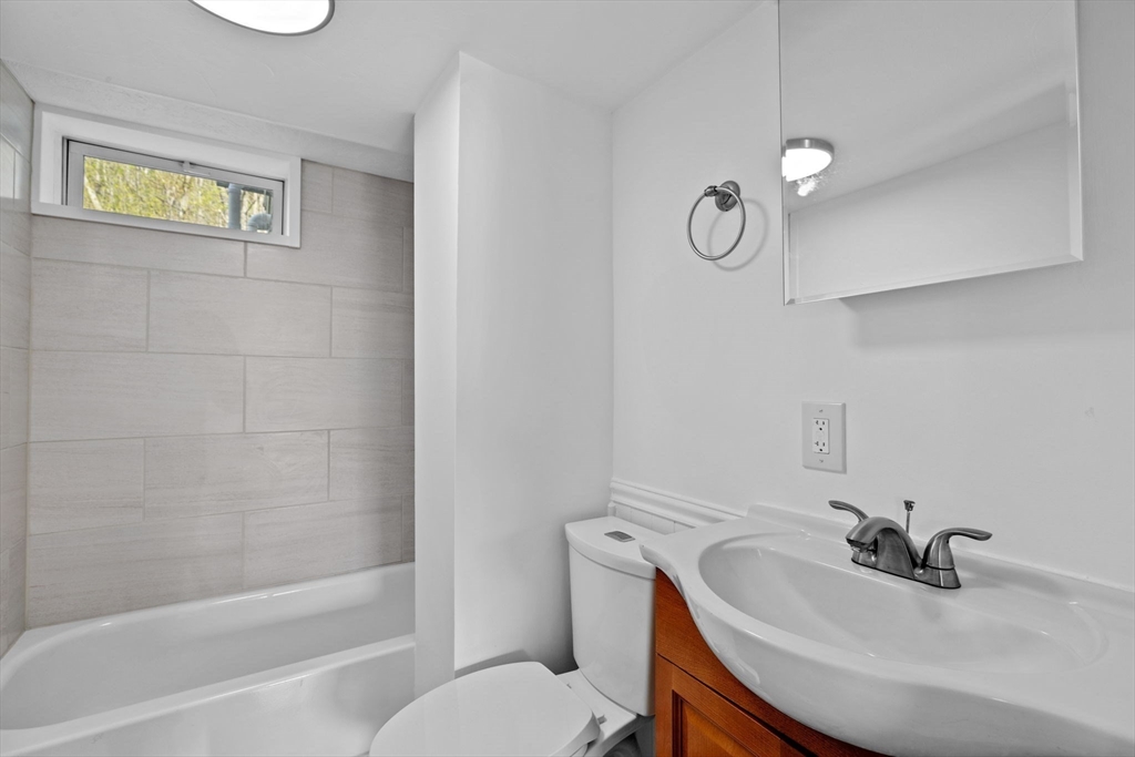 435 Newport Road Hull, MA 02045 - Photo 8 of 35 a bathroom with a sink a toilet and bathtub