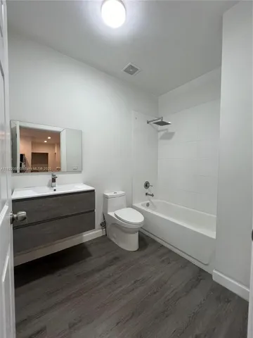 a bathroom with a sink a toilet and a tub