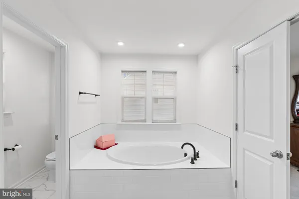 a bathroom with a sink a light fixture a vanity and a mirror
