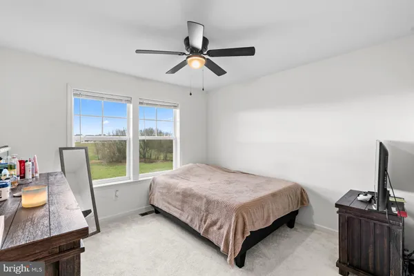 a bedroom with a bed and a potted plant