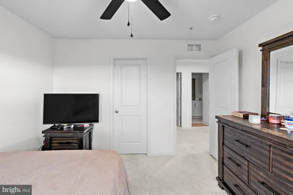 a bedroom with a bed and a lamp