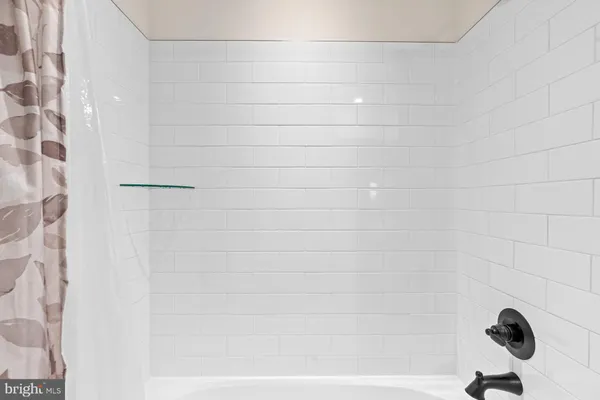 a white toilet sitting next to a white wall