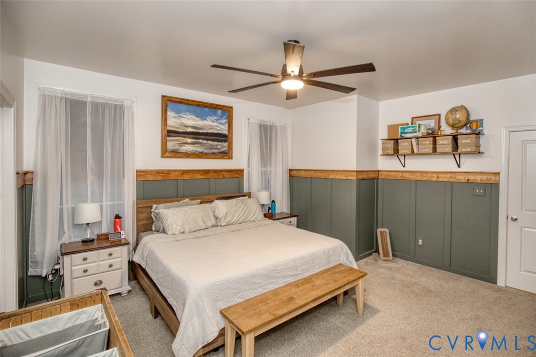 27 Trail Street Hampton, VA 23669 - Photo 19 of 36 a bedroom with a large bed and a chandelier