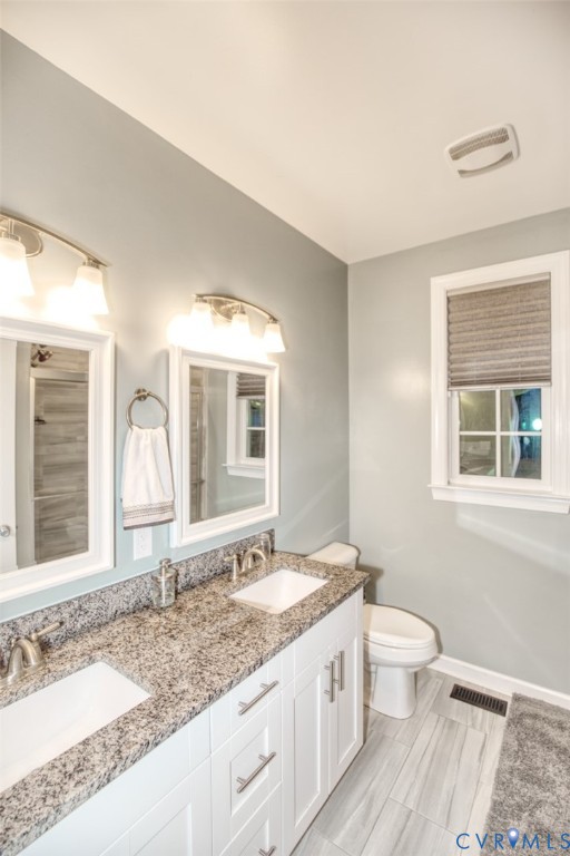27 Trail Street Hampton, VA 23669 - Photo 20 of 36 a bathroom with a granite countertop sink and a large mirror