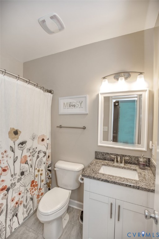 27 Trail Street Hampton, VA 23669 - Photo 24 of 36 a bathroom with a granite countertop toilet a sink and a mirror