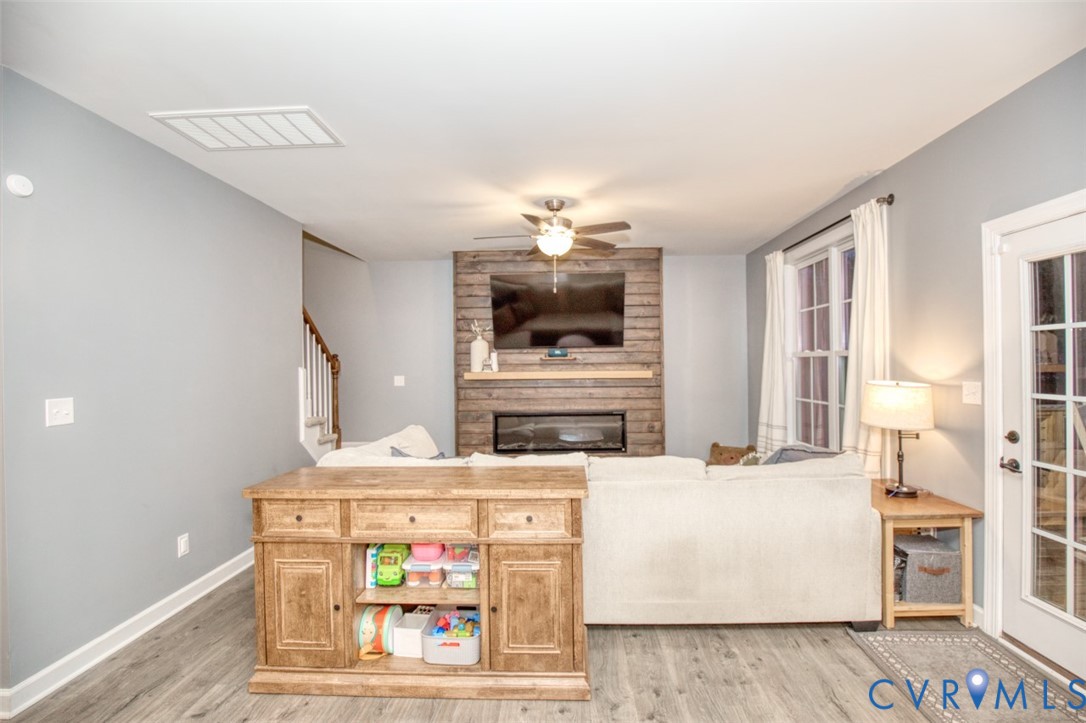 27 Trail Street Hampton, VA 23669 - Photo 26 of 36 a living room with furniture a fireplace and a flat screen tv