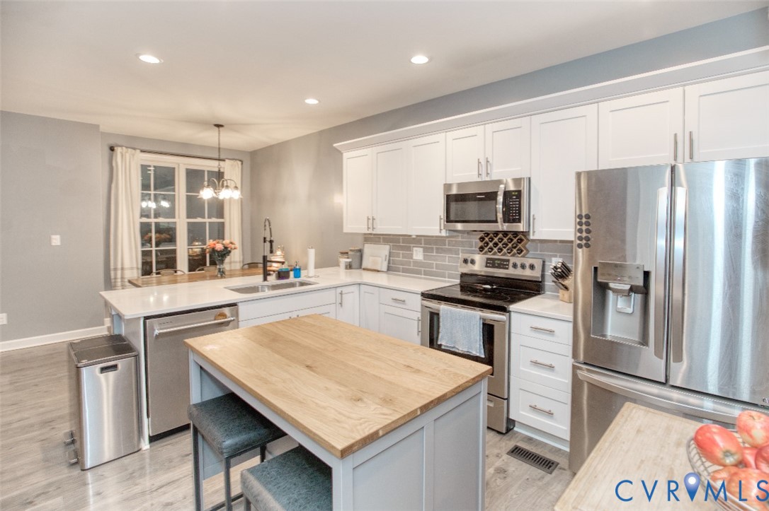 27 Trail Street Hampton, VA 23669 - Photo 32 of 36 a kitchen with granite countertop a refrigerator stove top oven and sink