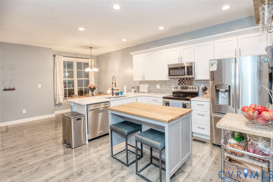 27 Trail Street Hampton, VA 23669 - Photo 6 of 36 a kitchen with stainless steel appliances kitchen island granite countertop a sink and cabinets