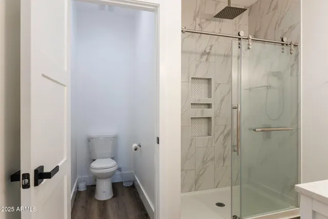 a white toilet sitting next to a bathroom sink