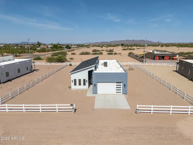 an aerial view of a house with a ocean view