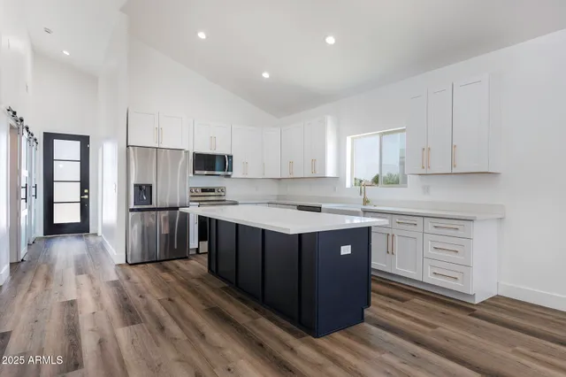 a kitchen with wooden floors and wooden cabinets