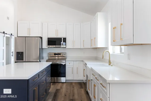 a kitchen with a sink stove and refrigerator