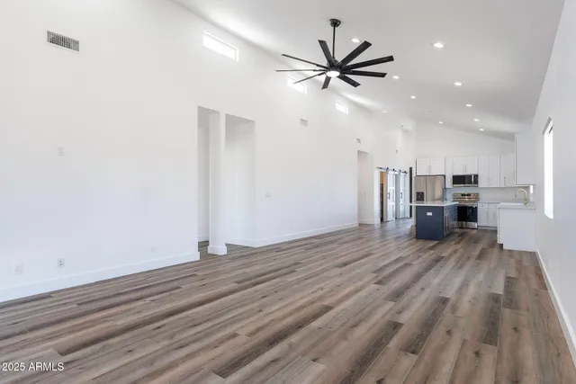 a view of a livingroom with a hardwood floor and a ceiling fan