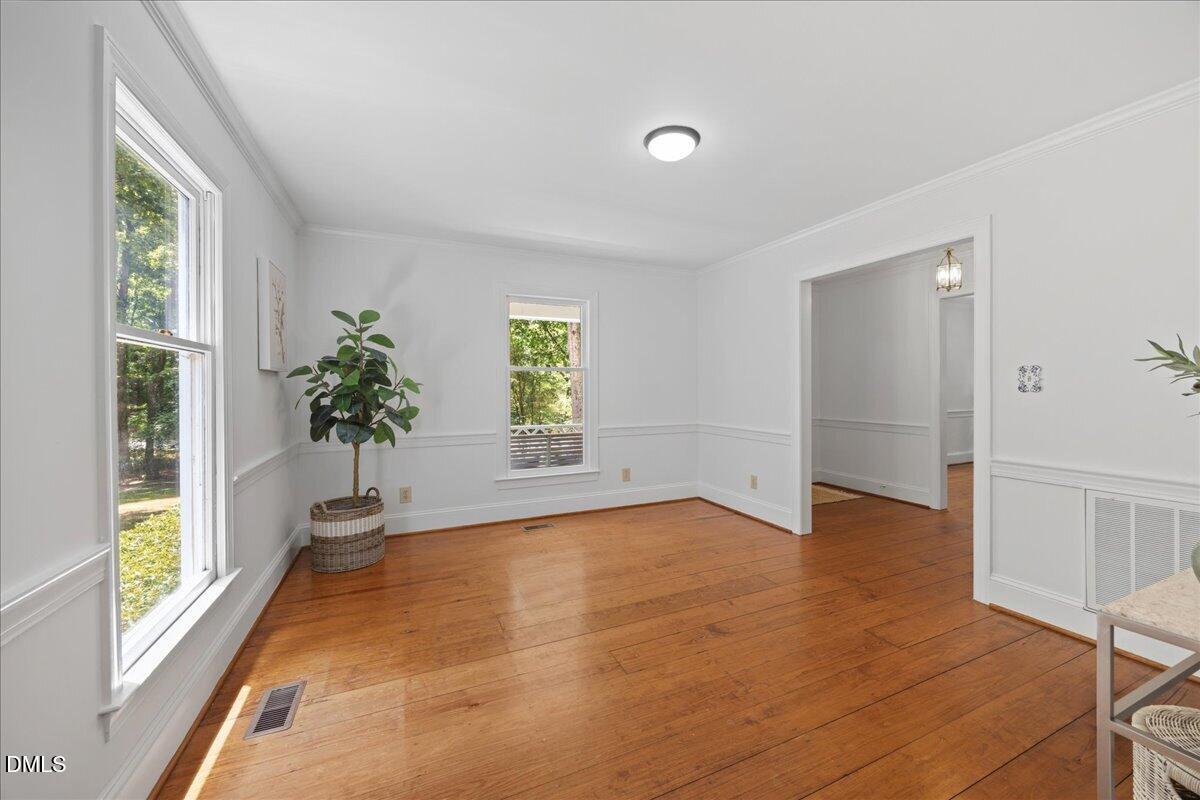 6516 Bakersfield Drive Raleigh, NC 27606 - Photo 26 of 59 a view of an empty room with a window and wooden floor